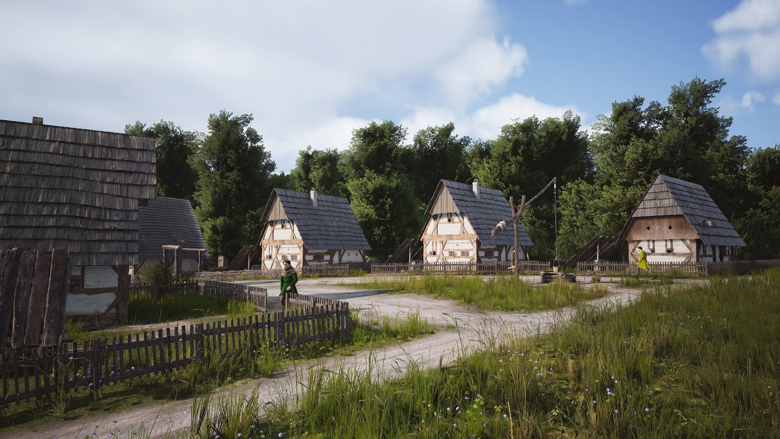 Manor Lords screenshot of small houses framing a dirt pathway nearby a field