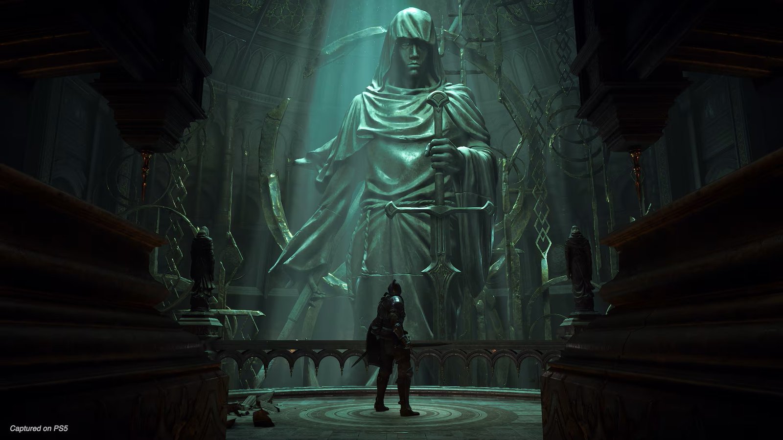 In Demon's Souls on PS5, the Demon Slayer protagonist stands before a statue of a robed woman holding a sword